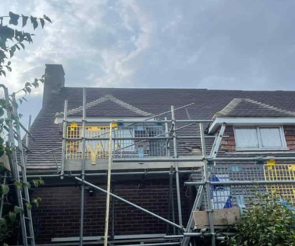 This is a photo of a roof with two dormers that is having some damaged tiles replaced. Works carried out by HJT Roofing Gainsborough